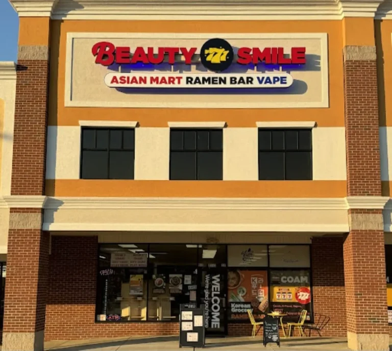Beauty Smile, Augusta, GA: storefront exterior with sign reading Beauty Smile, Asian Mart Ramen Bar Vape, strip mall building with sidewalk sign and outdoor seating